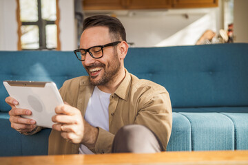 One Man caucasian Holding Digital Tablet work at home Happy Smile