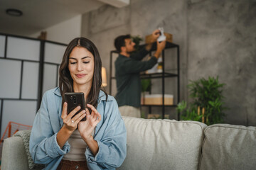 Wife navigate with cellphone her husband how to set cctv camera