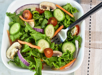   cucmbers, tomatoes  onions and mushrooms  in this garden salad