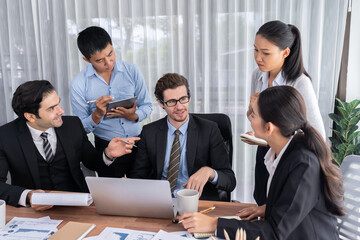Diverse of business people from various ethnic group working in modern office environment. Productive and multi ethnic office workers engage in discussion for strategic business marketing. Meticulous