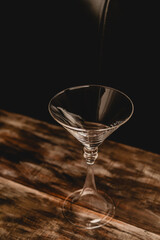 low key empty martini glass over wooden table 