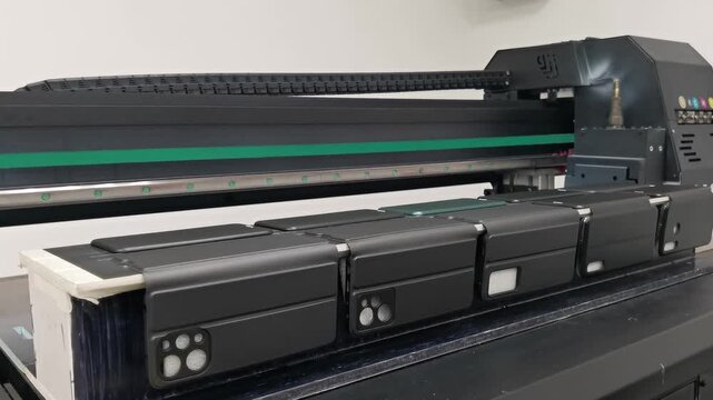 A modern digital large-format UV printer prints images on smartphone cases. UV pinning is the process of applying a dose of low intensity ultraviolet light to a UV curable ink