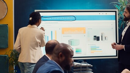 Employees team sharing insight on sales statistics in corporate briefing meeting, providing initiatives to enhance operational efficiency and agility. Group of business associates. Camera A.