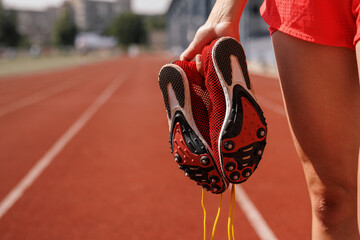 Red Athletic Shoes on Running Track