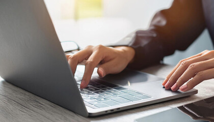 Closeup of Businesswoman Working on Laptop and Tablet with blurred office background