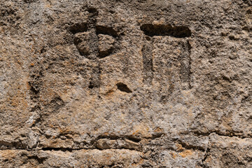 Old stone inscription carved in stone. Greek letters.