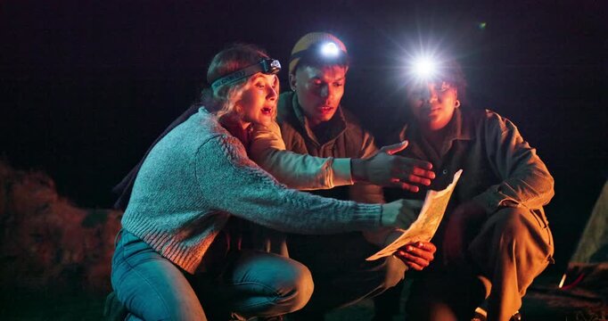 Night, hiking and people with map for direction, navigation and travel in dark with route on paper. Planning, trekking and group fight about decision on journey to location, path or lost in nature