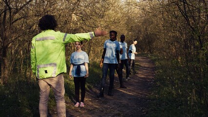 As the mission for the lost individual grows worse, supervisor of the rescue operation team guides his crew into the forest in search of clues. People screaming for missing person's name. Camera B.