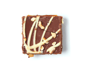 Cake portion with dark and white chocolate and nuts on white background. High quality pastry product. Premium sweet desert for tea or coffee.