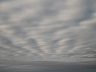The sky is cloudy and the sun is not visible. The clouds are white and grey. Nature background.