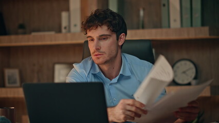 Angry businessman disappointed failure looking laptop at evening office close up