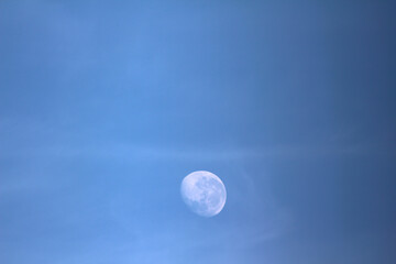moon over blue. moon in the sky. moon appearing during the day.