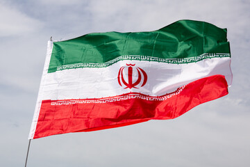 Iran flag waving against the blue sky