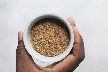 Overhead view of ground dried crayfish, top view of dried shrimp powder, flatlay of nigerian crayfish powder on a white background