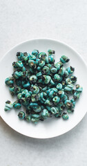 Overhead view of shelled periwinkles on a white plate, top view of fresh cleaned periwinkles,...