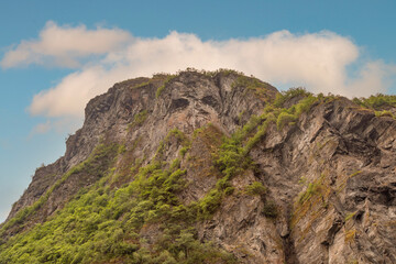A Scowling Grumpy Face Carved by Erosion into the Rock Face on the Cliffs Surrounding Geiranger Fjord in Norway