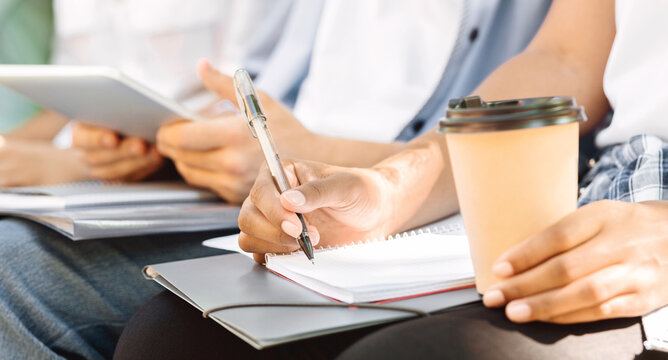 Unrecognizable Student Girl Writing Essay Outdoors, Preparing For Classes With Her College Friends Together, Cropped Image, Closeup