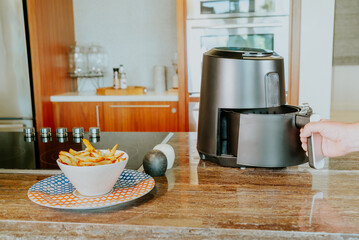 Air fryer being operated in a kitchen