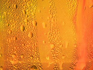 Drops of water on a red-orange coffee cup