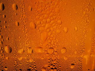 Drops of ice on a golden drinking glass