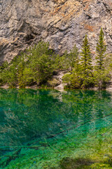 Breathtaking views of the upper and lower Grassi Lakes with brilliant turquoise and aqua waters set in a serene wilderness outside the town of Canmore near Kananaskis during the summer season.