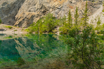 Breathtaking views of the upper and lower Grassi Lakes with brilliant turquoise and aqua waters set in a serene wilderness outside the town of Canmore near Kananaskis during the summer season.