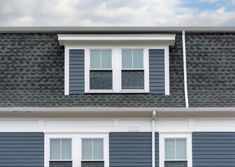close-up view of the upper portion of a residential building with dormer in Brighton, Massachusetts, USA