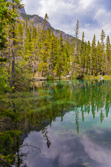 Obraz premium Breathtaking views of the upper and lower Grassi Lakes with brilliant turquoise and aqua waters set in a serene wilderness outside the town of Canmore near Kananaskis during the summer season.
