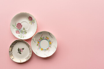 3 Antique China Plates on a Pink Background