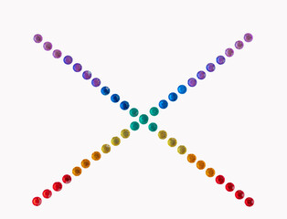 Crisscross rows of neon beads that sparkle make an x shape. Colors vary and make a bright fanciful isolated design. The jewel gems shine in the light.