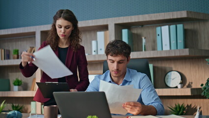 Confident ceo examining documents talking with woman assistant in office closeup - Powered by Adobe