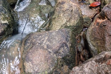 Dark grey stone texture background. Close up of stone surface. Broken, cracked, crumbling,...