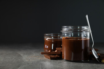 Chocolate paste in a jar on a dark background
