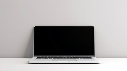 Fototapeta premium A contemporary laptop with a blank white screen sits on a white tabletop, surrounded by a clean, white environment. The focus is on the empty screen, 