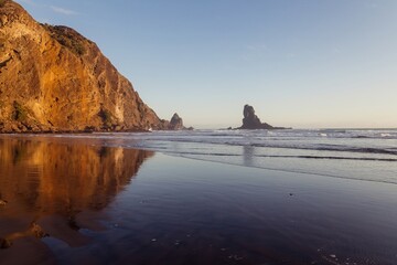 Coastal sandy beach of Anawhata at sunset, Piha, Auckland, New Zealand.