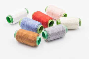 Colorful Spool of sewing thread, spool of industrial threads, Colored spools of thread on a white background.