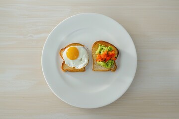 Two Toasts with Different Toppings on a White Plate