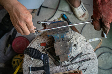 Man hand  Industrial worker welding metal at factory workshop