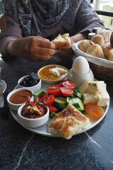 woman enjoying Turkish Breakfast Served at cafe 