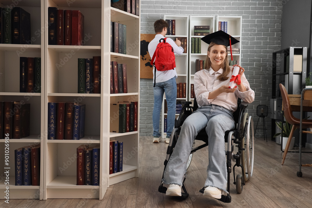 Canvas Prints Female graduate in wheelchair with diploma at library