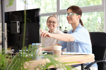 Female programmers working at table in office