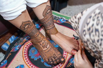 Mumbai, India 23rd July 2024: Close-up shots of an Indian bride getting henna also known as Mehendi...