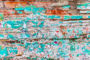 Abstract of peeling paint on a brick wall.