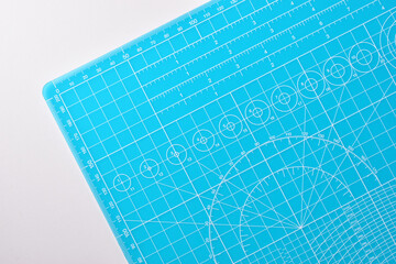 blue cutting mat board on white background with line and scale measure guide pattern for object art...