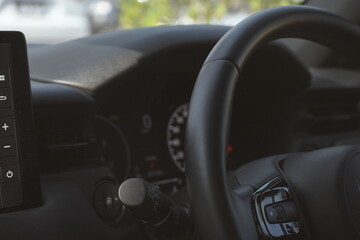 interior view of car with black leather, steering wheel with button