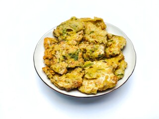 Traditional fried tempeh, or tempeh mendoan, or deep fried tempeh with spiced batter, is one of the most the most popular street foods from Indonesia. Fried tempeh on the plate on the white background