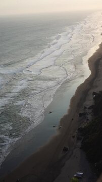 High-angle long view of the wave in the Indian Ocean at Parangtritis Beach.