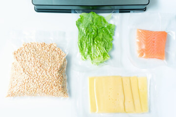 Different types of food packed in vacuum bags on white background top view.