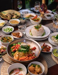  A beautifully presented dish of Khao Kluk Kapi, a traditional Thai dish made with fragrant rice, crispy pork belly, and fresh shrimp. The dish is served with a side of raw vegetables for a refreshing