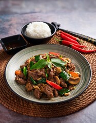 A sizzling plate of stir-fried beef with holy basil, chili peppers, and aromatic spices. This classic Thai dish is a favorite among locals and foreigners alike.